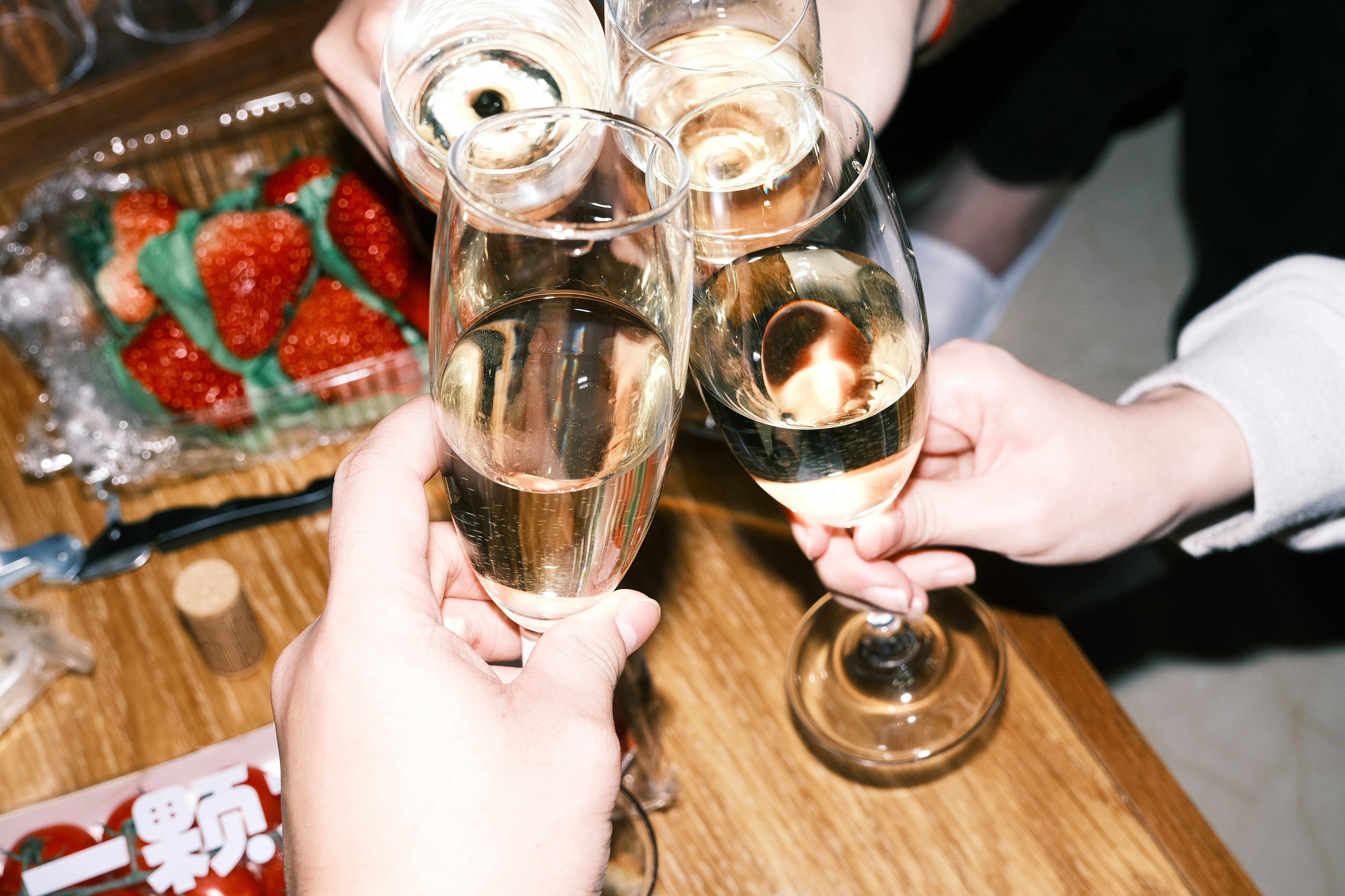 Group champagne toast at a restaurant on New Year’s Eve.