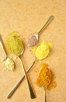 A group of spoons filled with different types of food