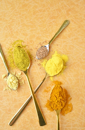 A group of spoons filled with different types of food