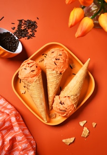 A plate with three ice cream cones on it