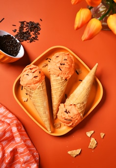 A plate with three ice cream cones on it