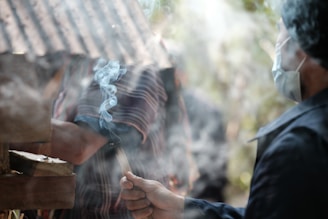 A man is cooking on a grill outside
