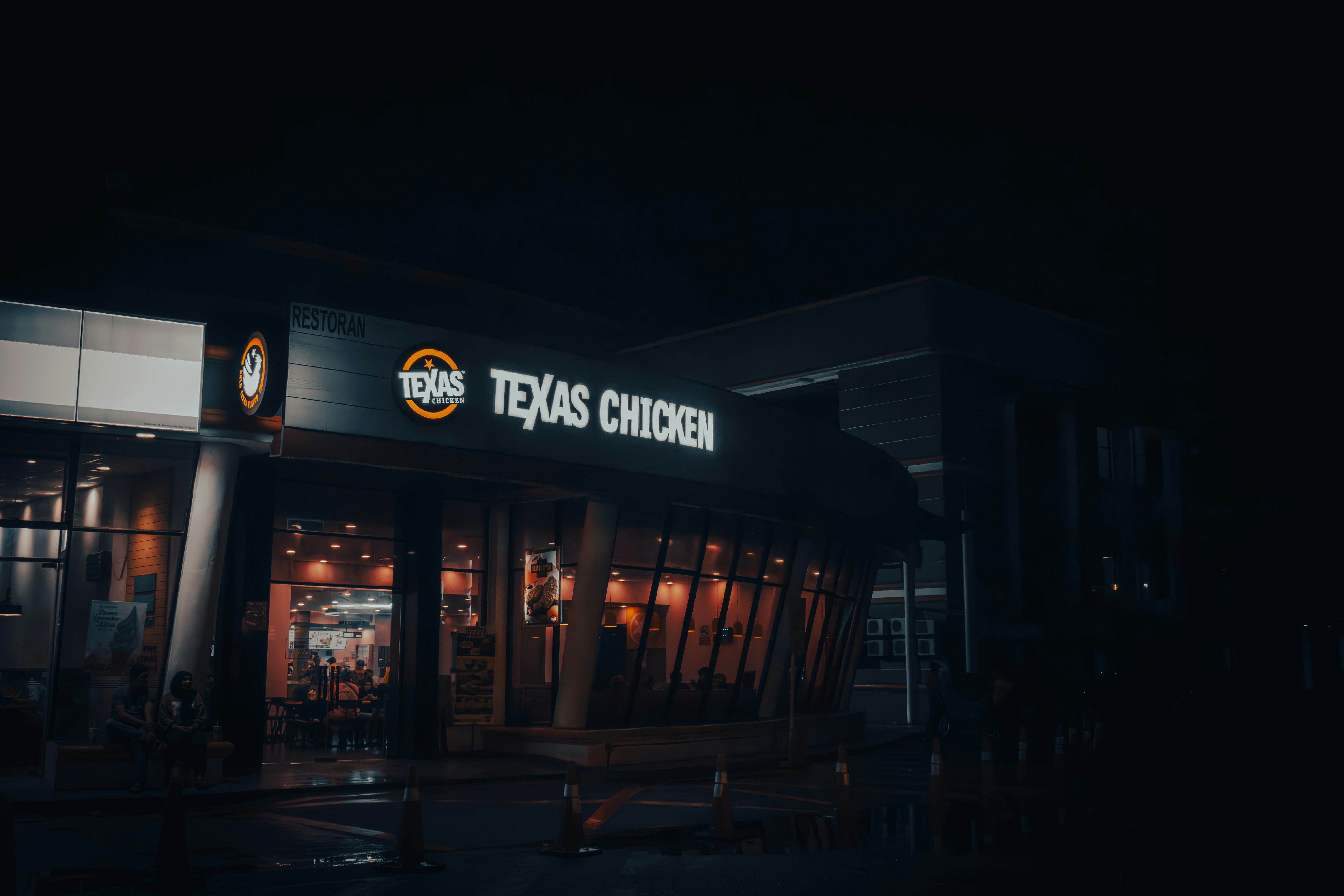 A gas station at night with the lights on