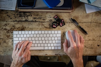 A person is typing on a computer keyboard