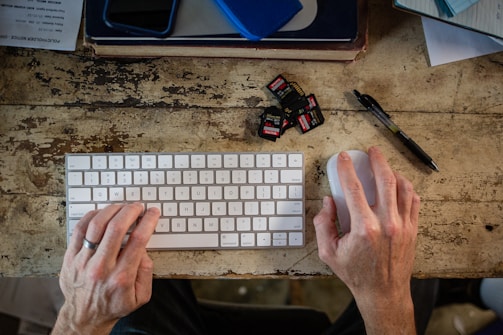 A person is typing on a computer keyboard