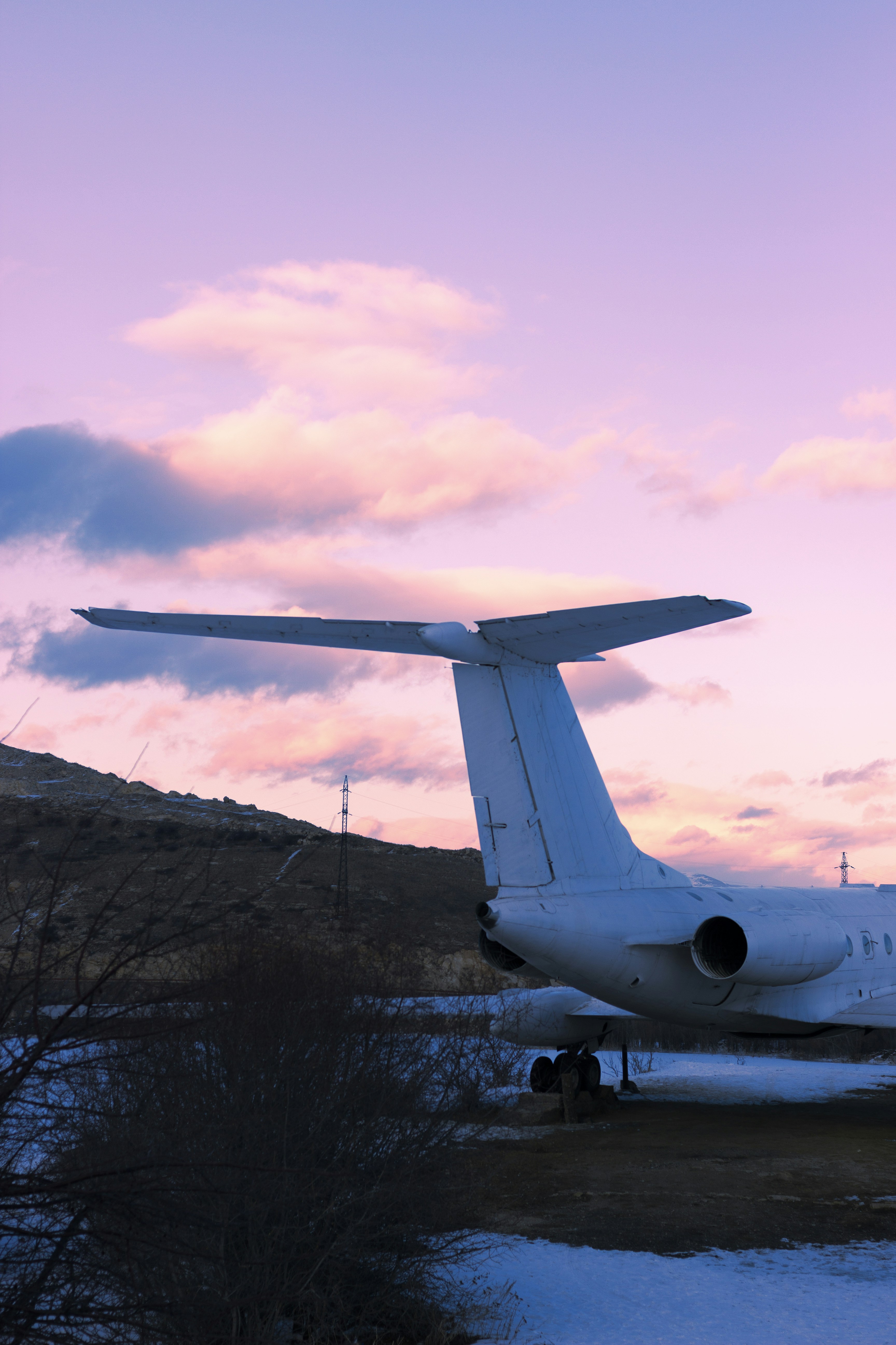A plane is parked on a snowy runway