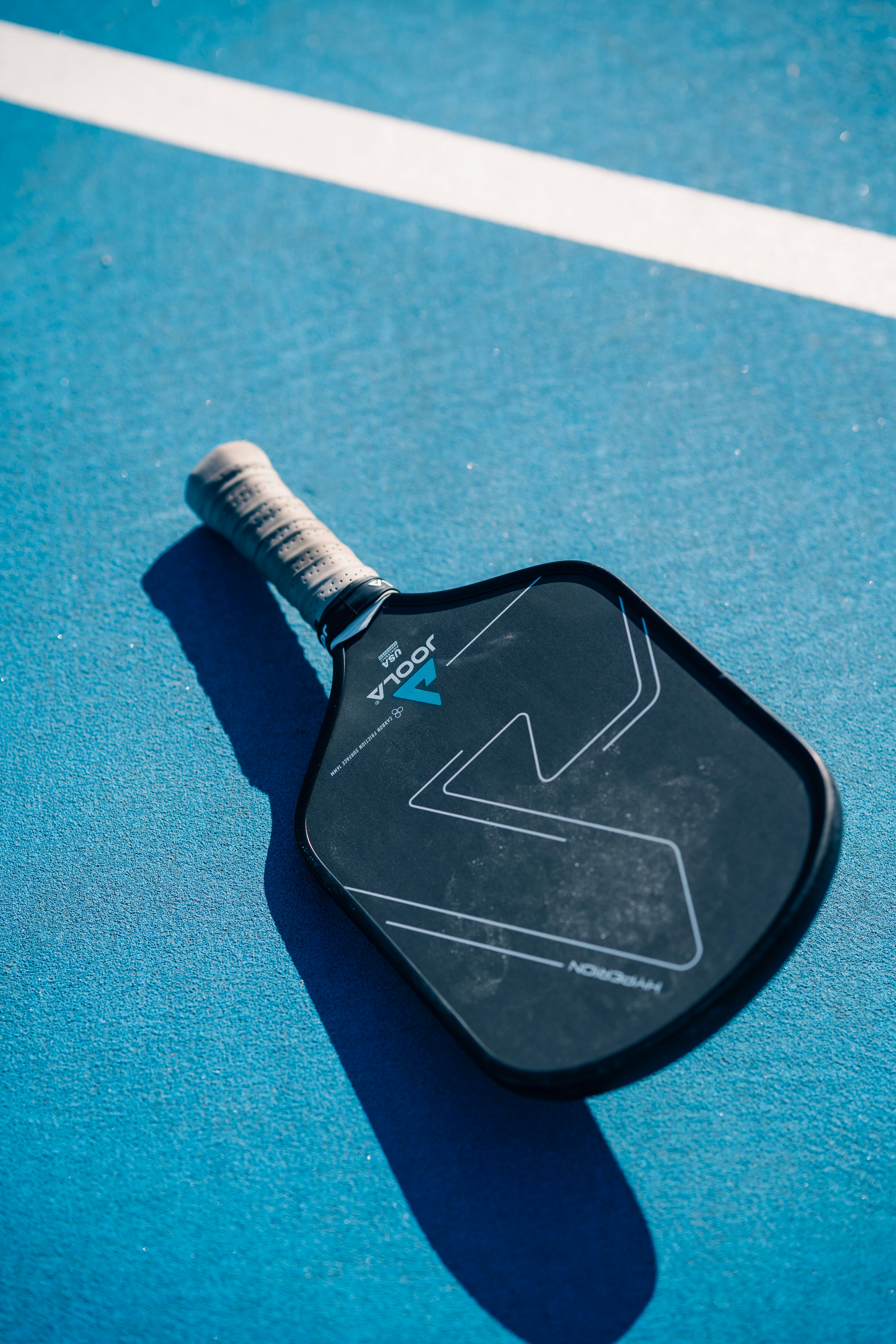 A close up of a tennis racket on a court