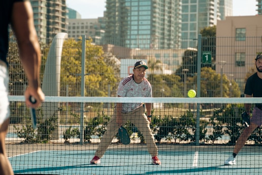 A group of men playing a game of tennis