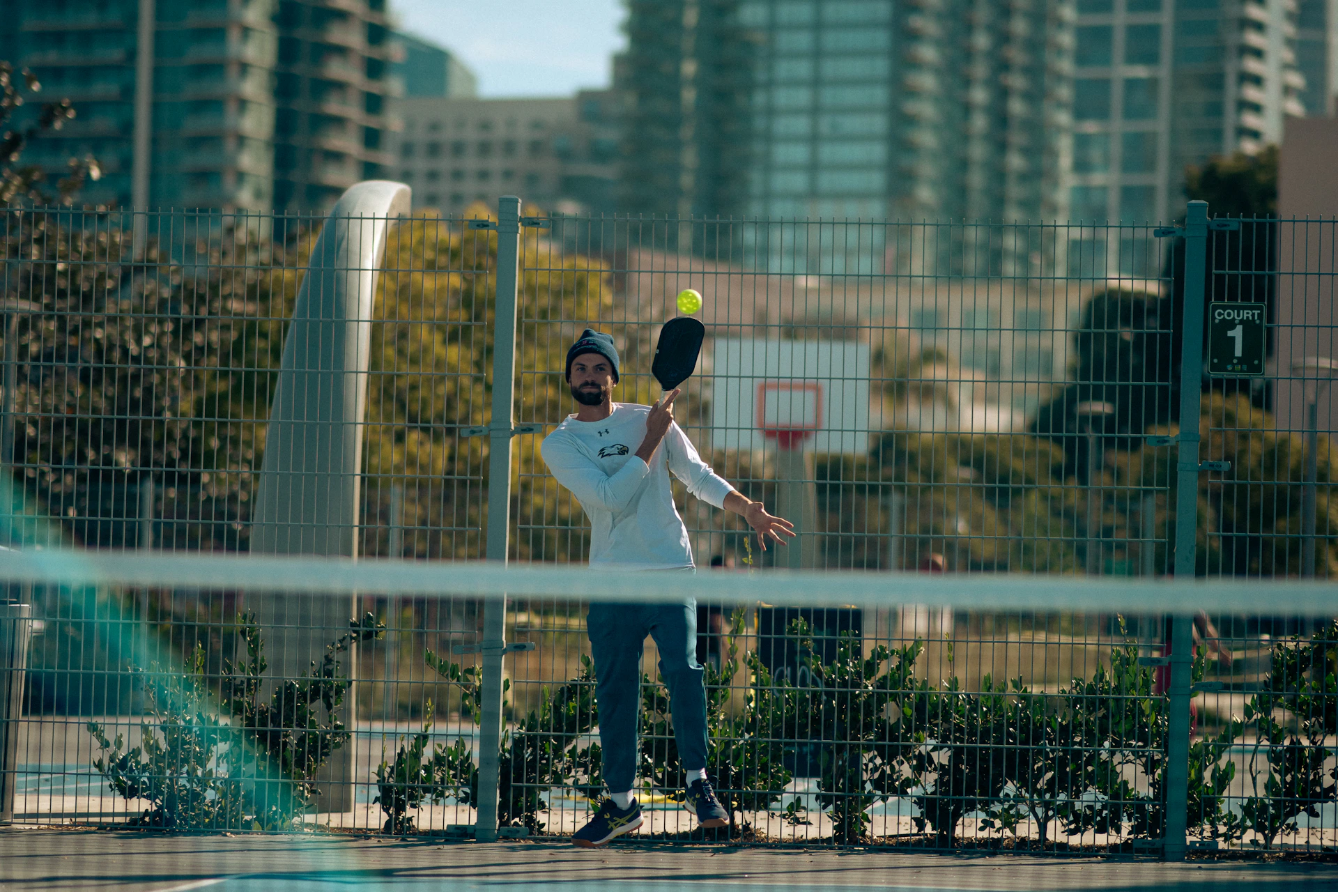 A man holding a tennis racquet on top of a tennis court