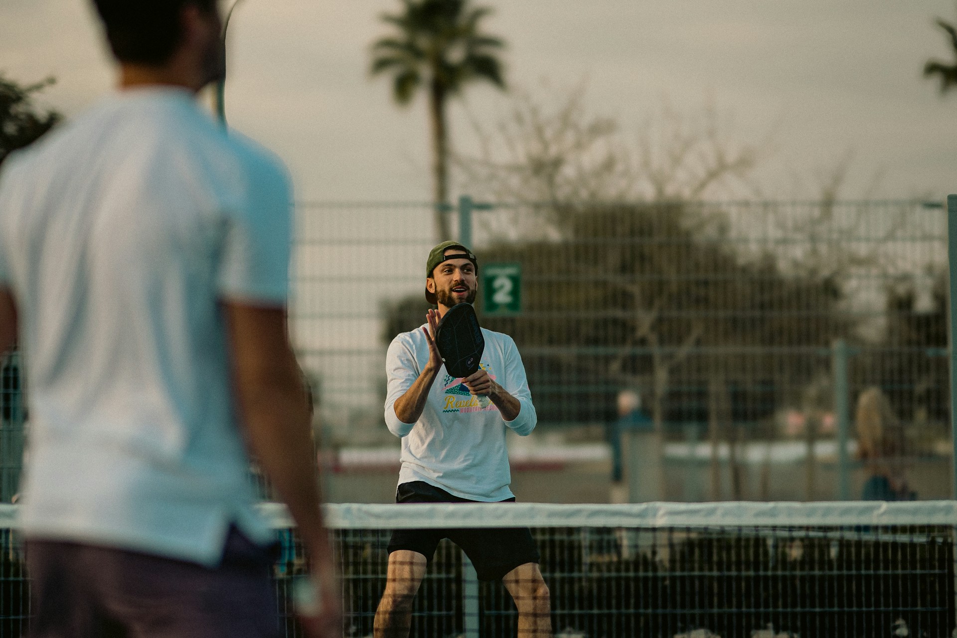 A man standing on a tennis court holding a tennis racquet