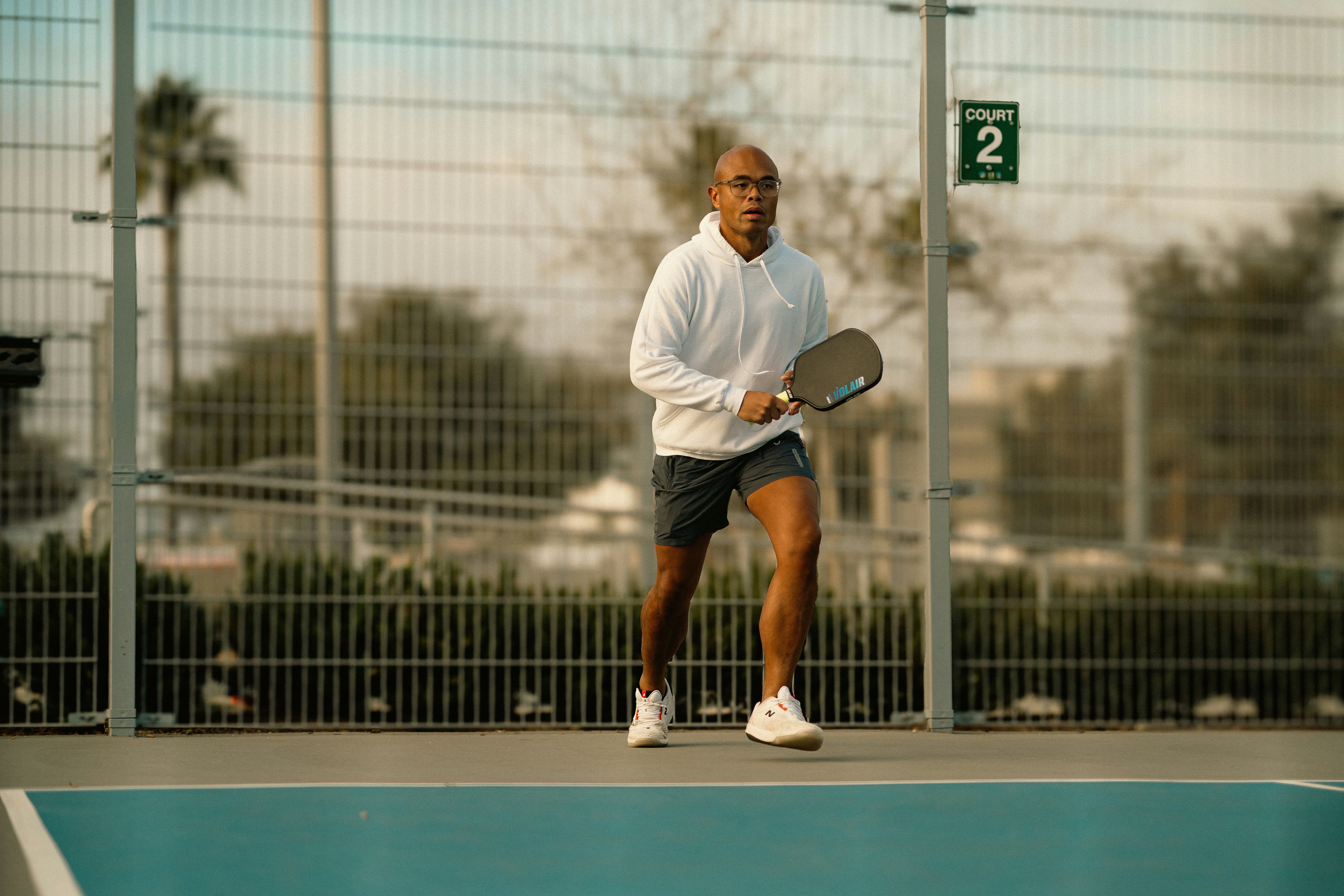 A man holding a tennis racquet on a tennis court