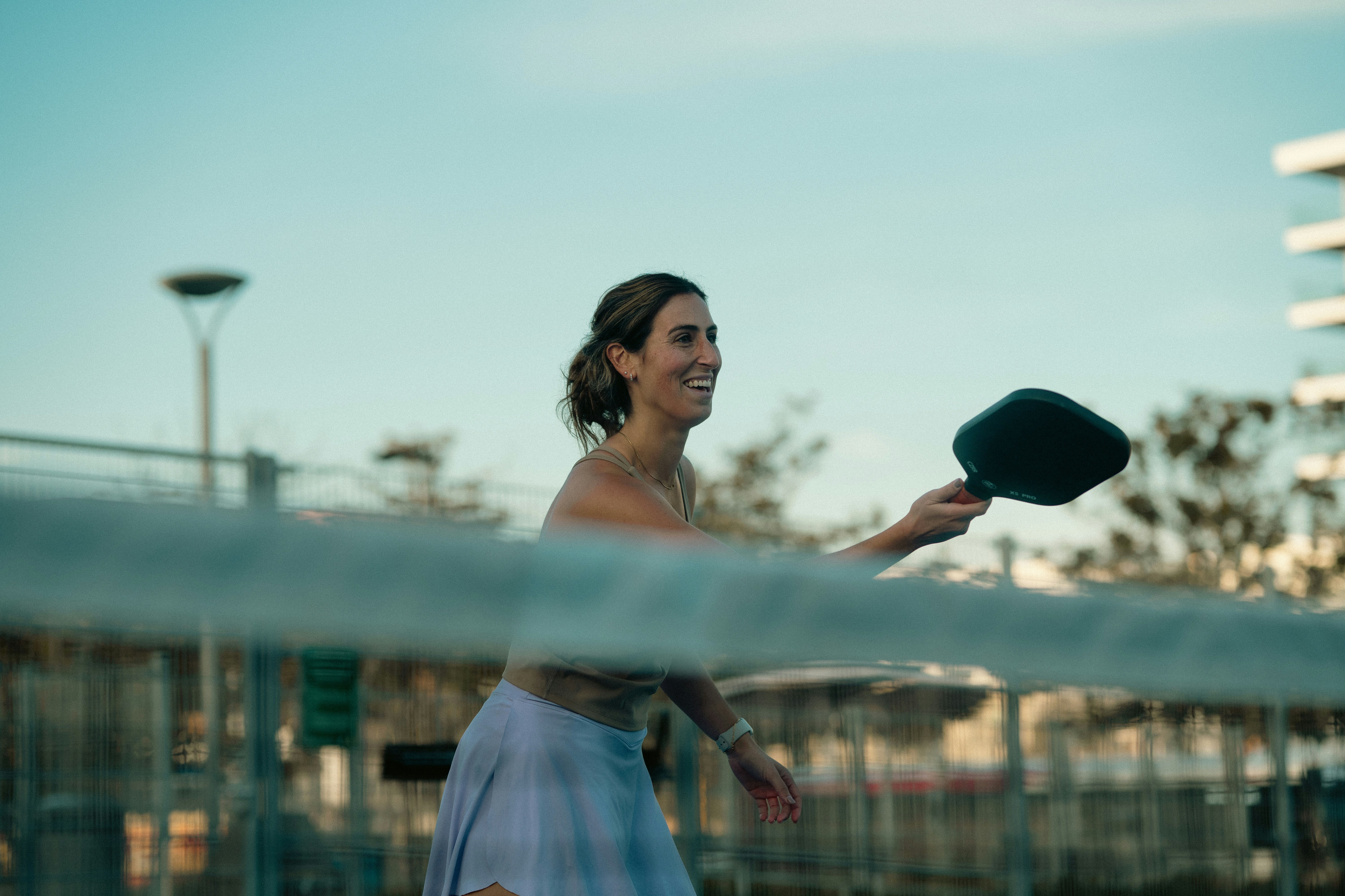 A woman holding a tennis racquet on top of a tennis court