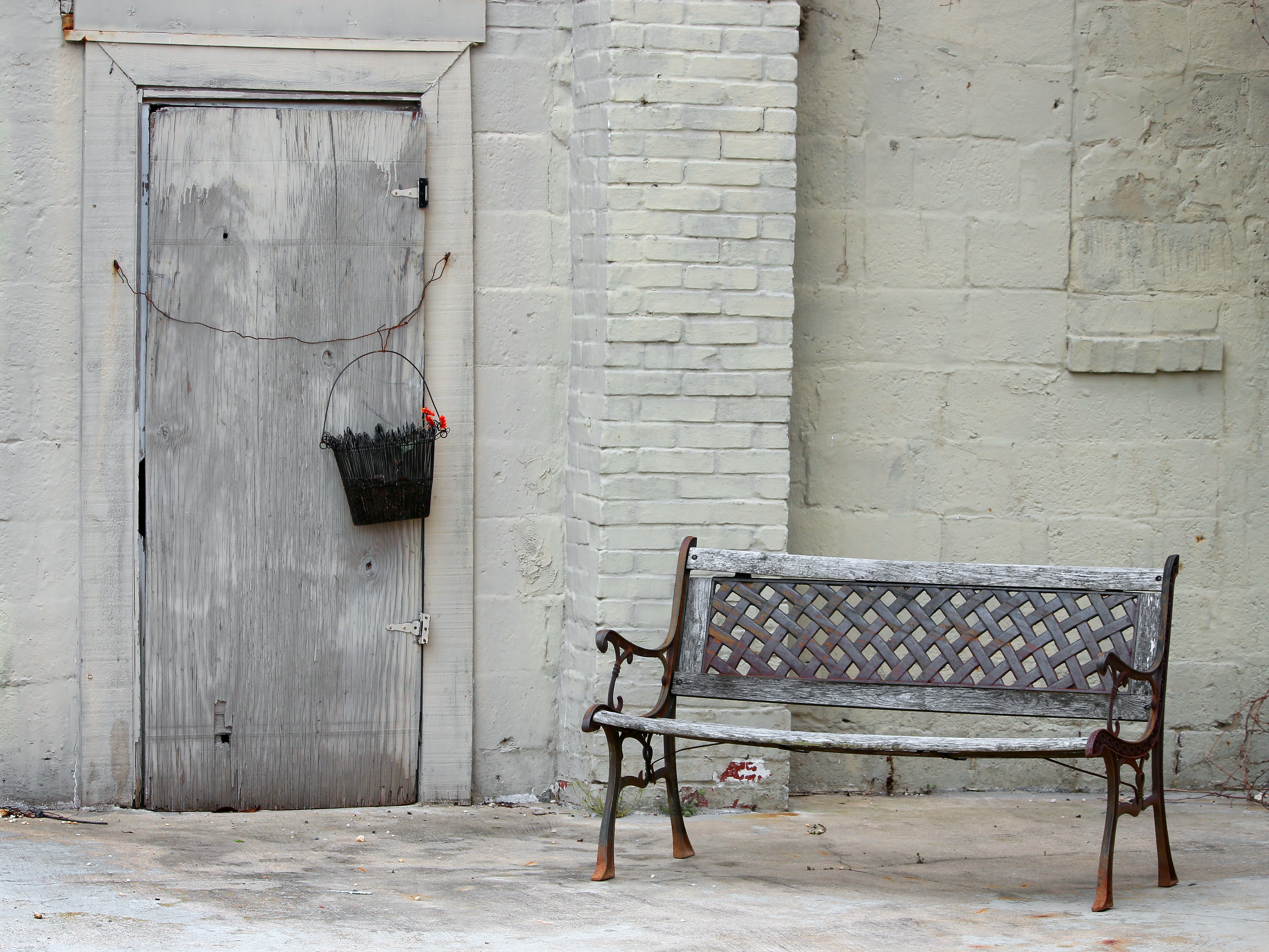 A bench sitting in front of a building
