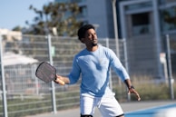 A man holding a tennis racquet on a tennis court