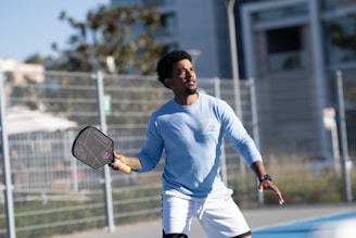 A man holding a tennis racquet on a tennis court