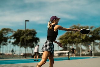 A woman is playing tennis on a court