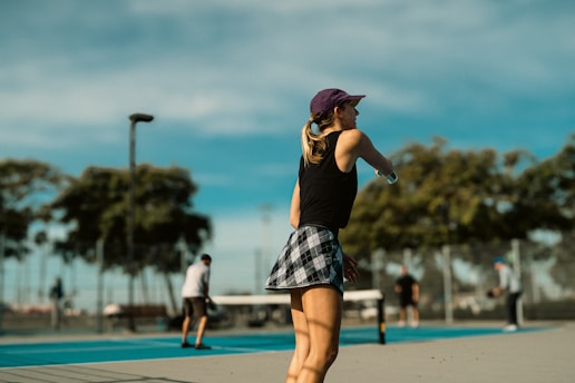 A woman standing on a skateboard in a skate park