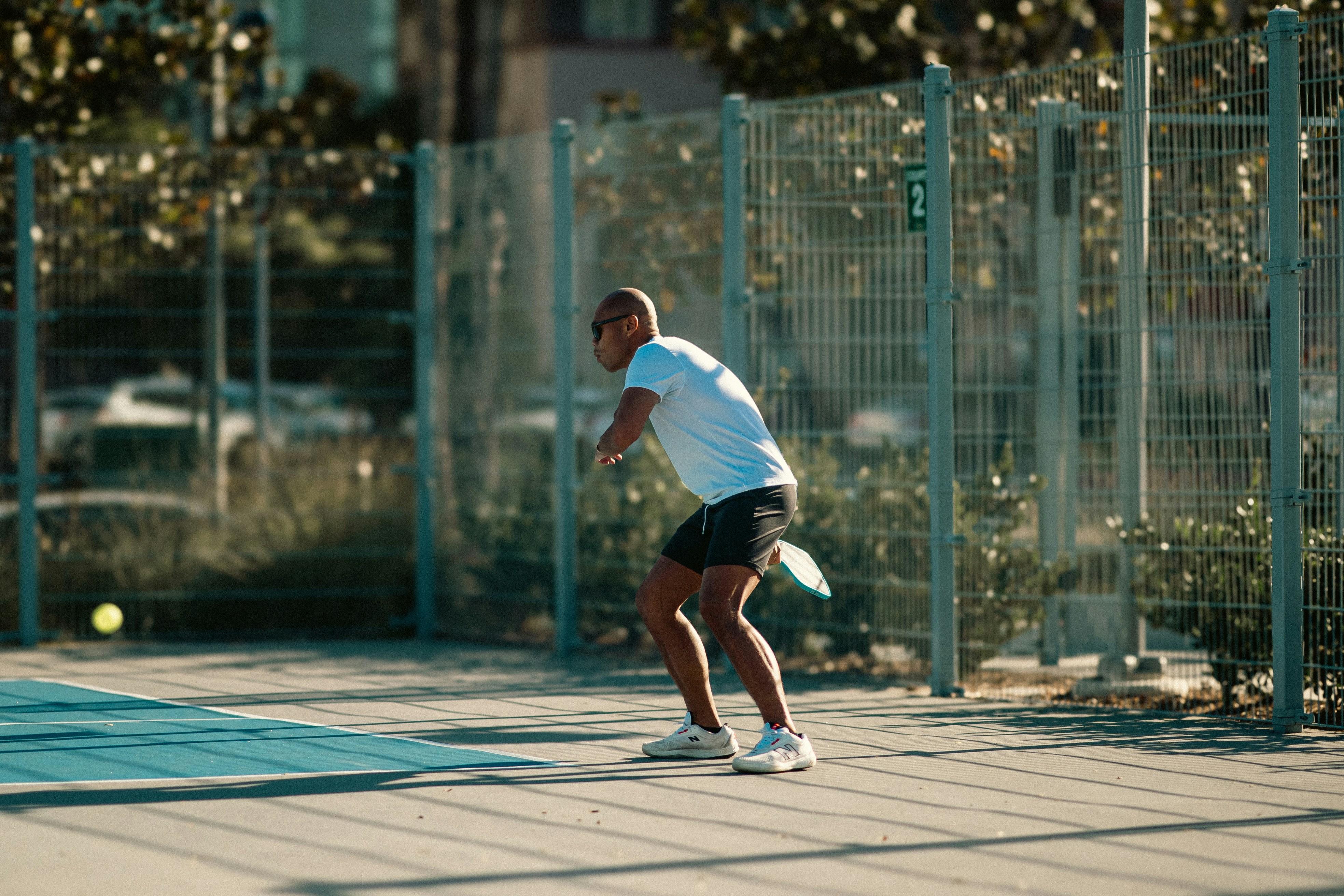 A man is playing tennis on a court