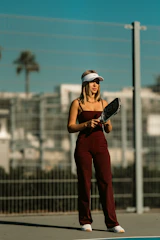 A woman holding a tennis racquet on top of a tennis court