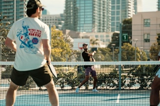A group of people playing tennis on a tennis court