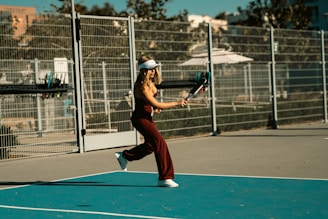 A woman holding a tennis racquet on a tennis court