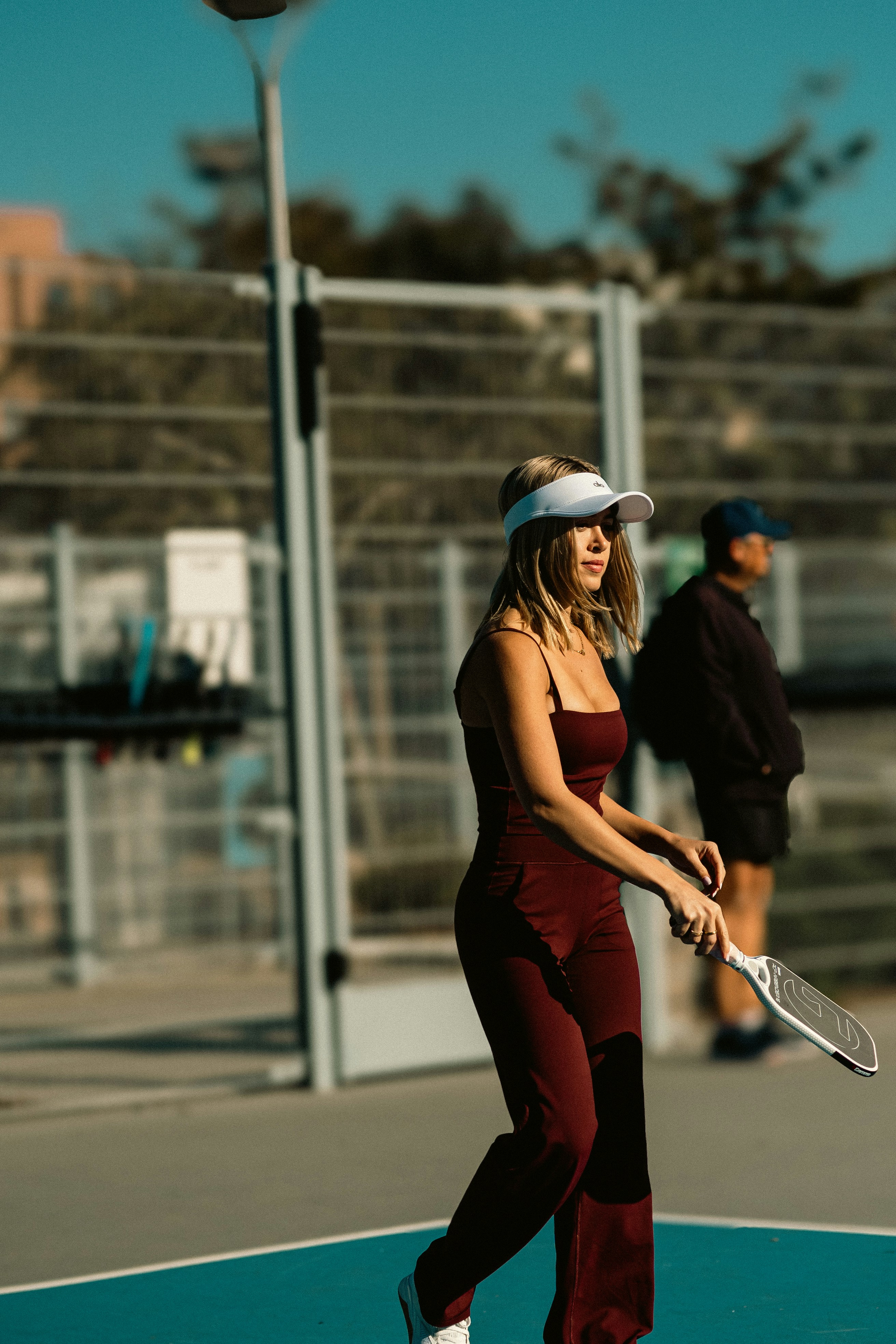A woman holding a tennis racquet on a tennis court