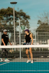 A couple of people that are standing on a tennis court