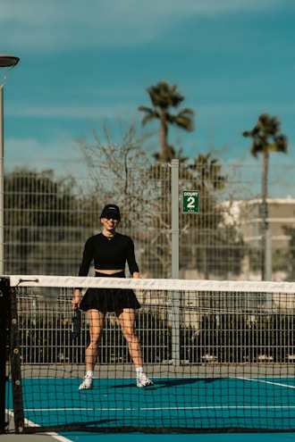A woman standing on a tennis court holding a racquet