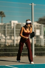 A woman holding a tennis racquet on top of a tennis court