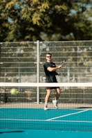 A man swinging a tennis racquet on a tennis court