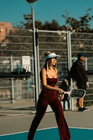 A woman holding a tennis racquet on top of a tennis court
