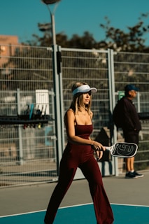 A woman holding a tennis racquet on top of a tennis court