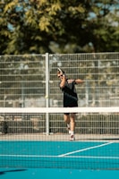 A man swinging a tennis racquet on a tennis court
