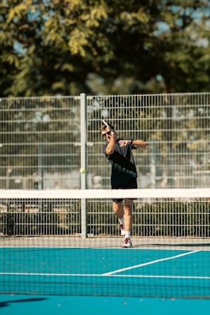 A man swinging a tennis racquet on a tennis court