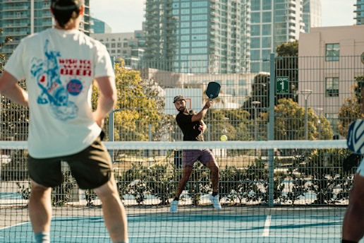 A group of people standing on top of a tennis court