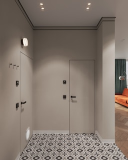 A bathroom with a tiled floor and two doors