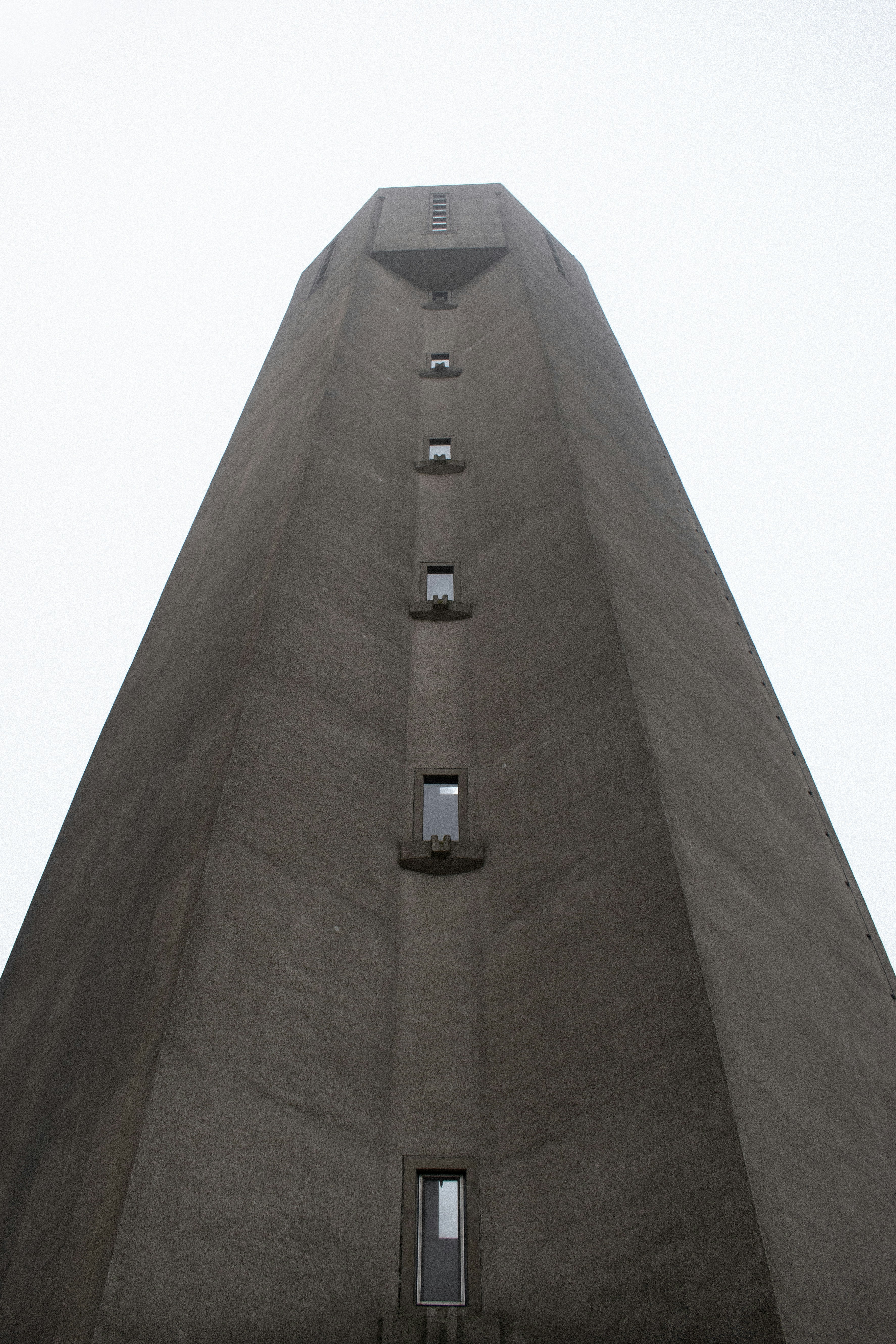 A very tall building with a clock on it's side