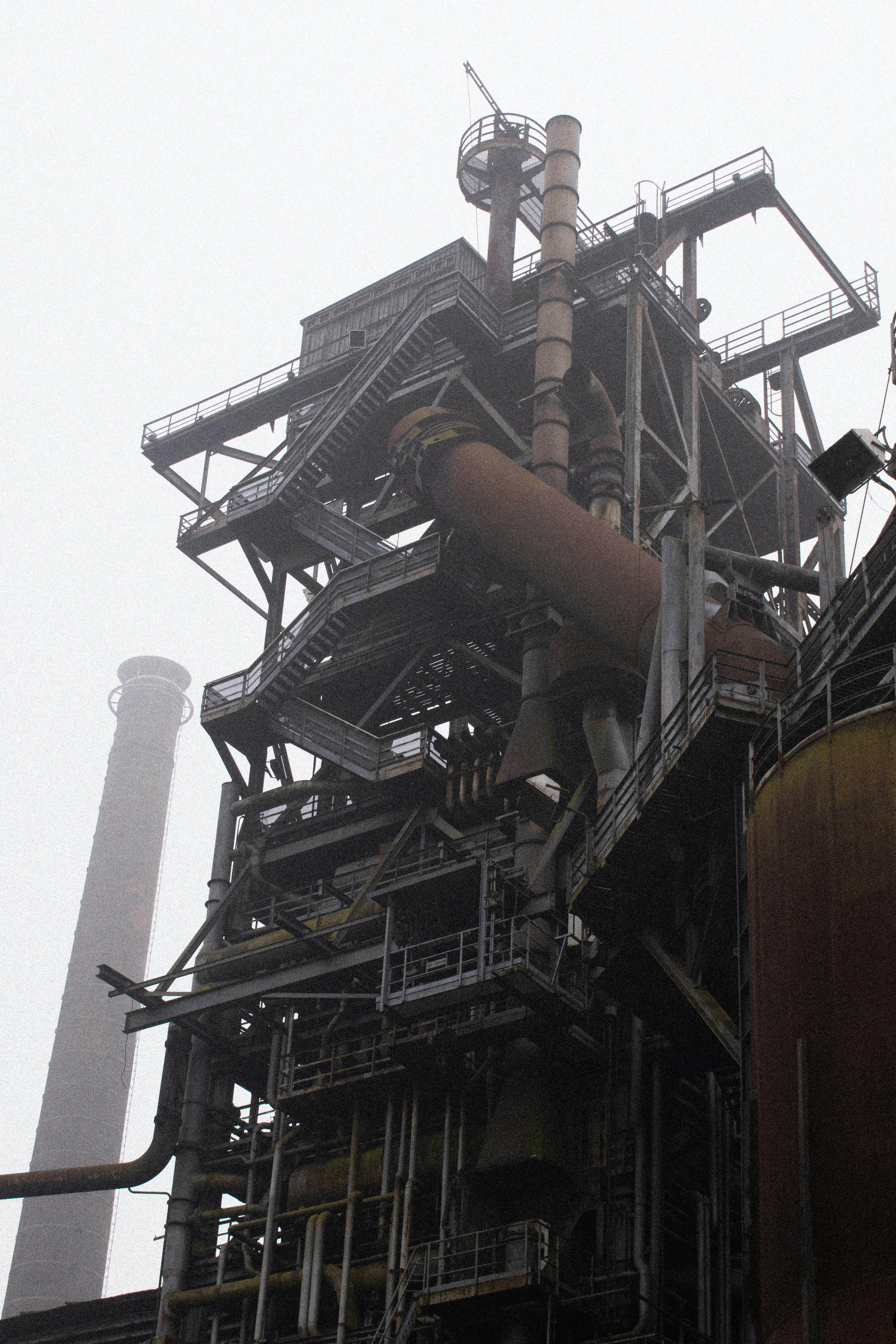 A large factory building with lots of pipes
