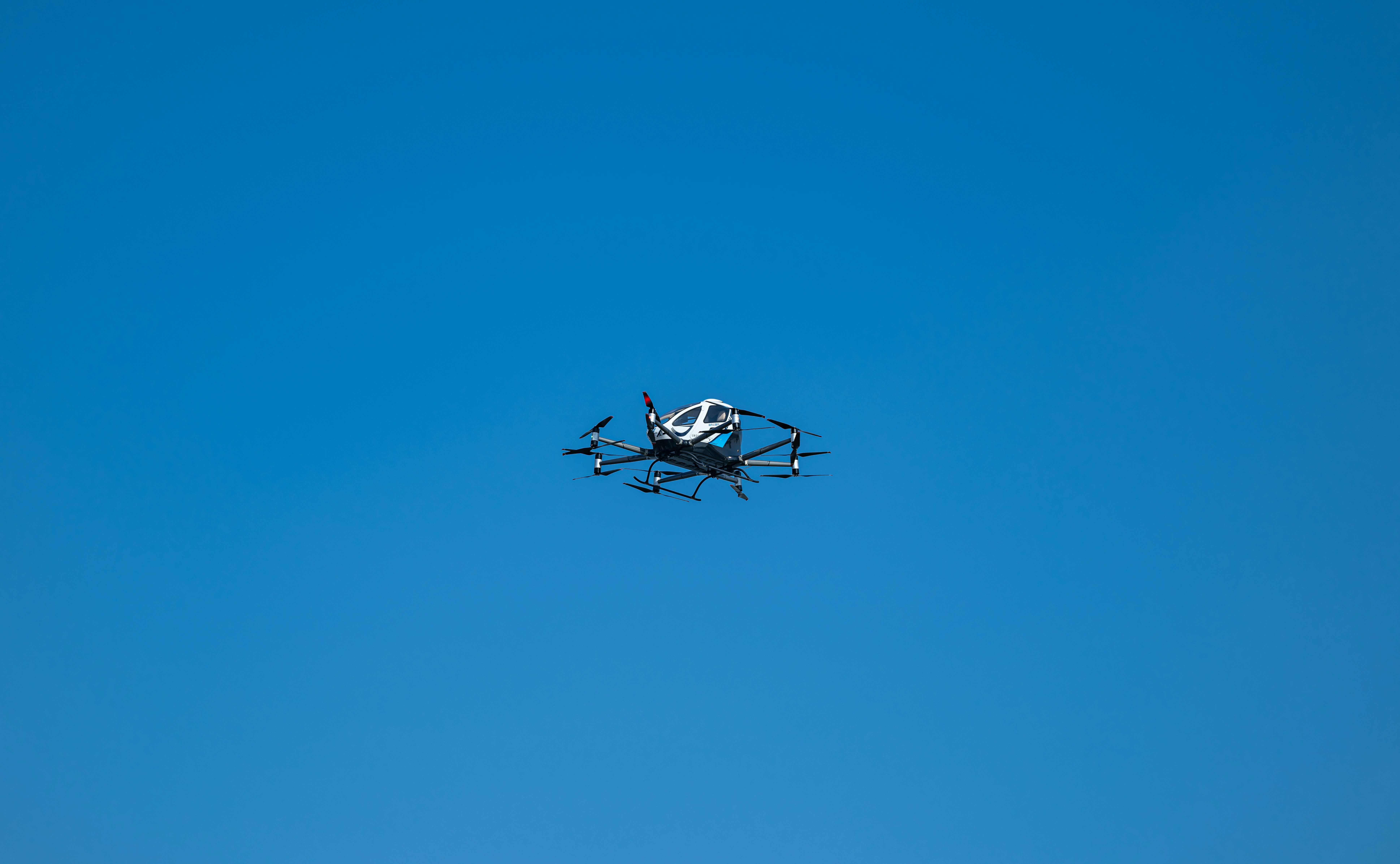 A small propeller plane flying through a blue sky, 