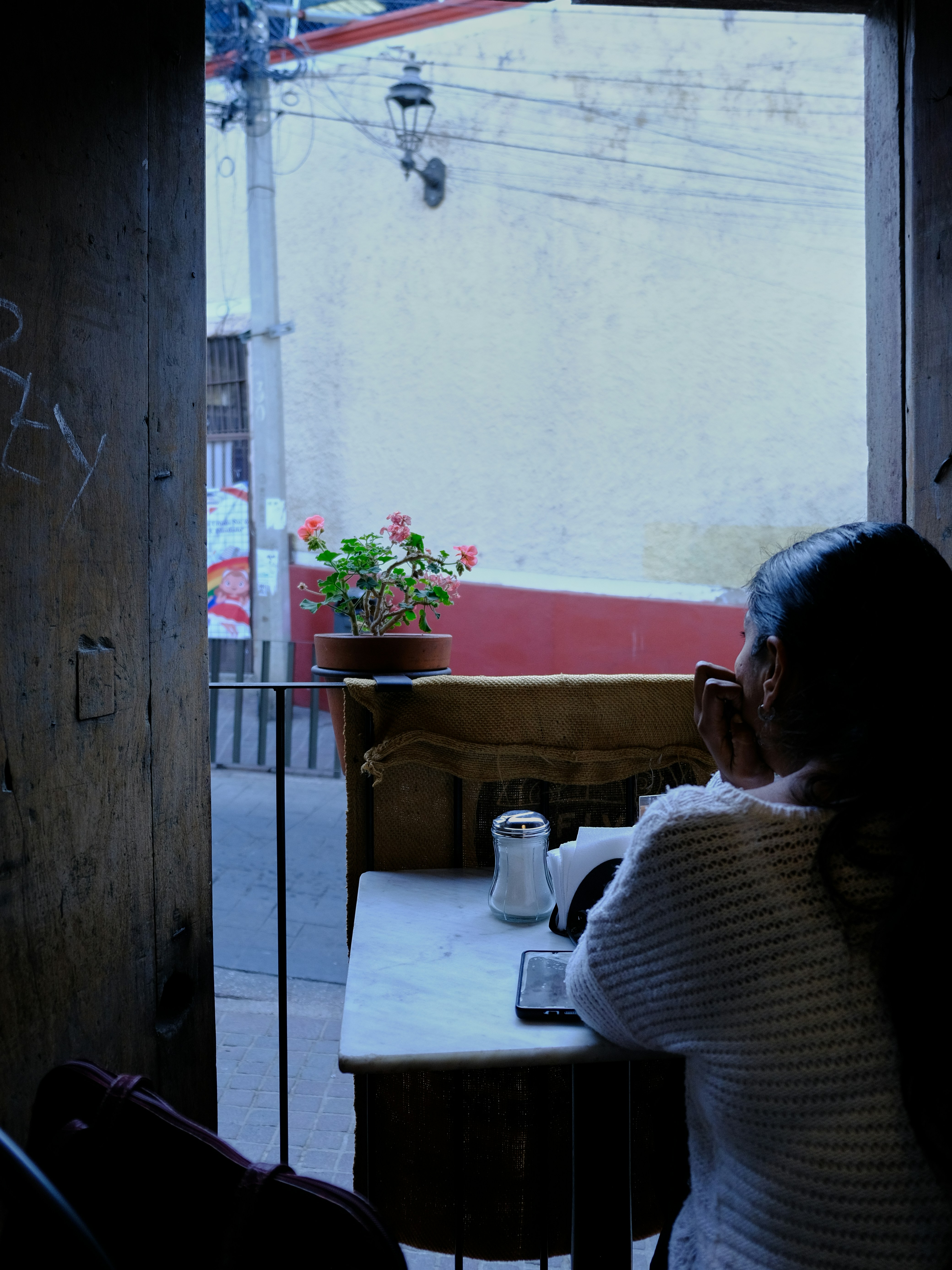 A woman sitting at a table in a dark room