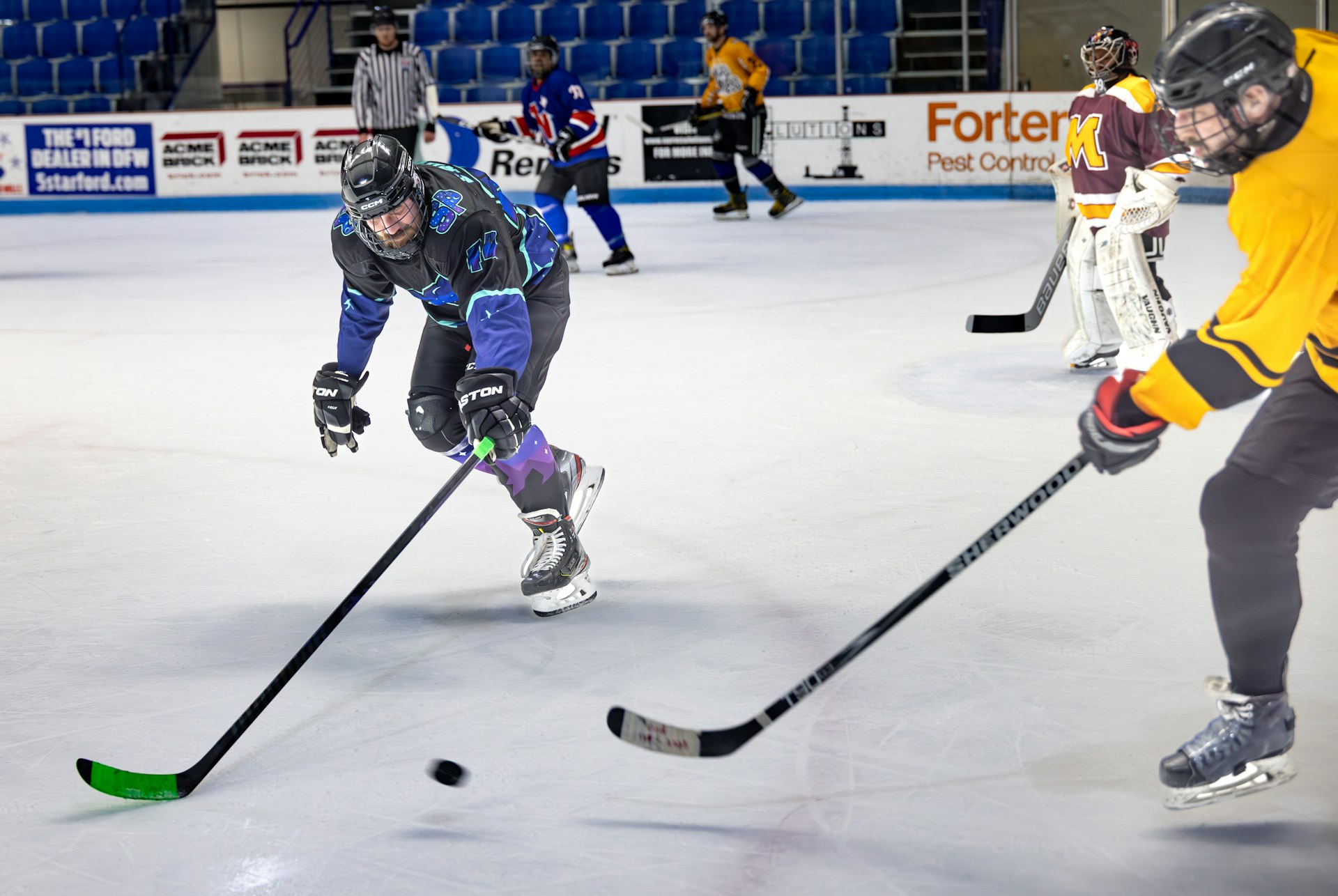 A group of young men playing a game of ice hockey