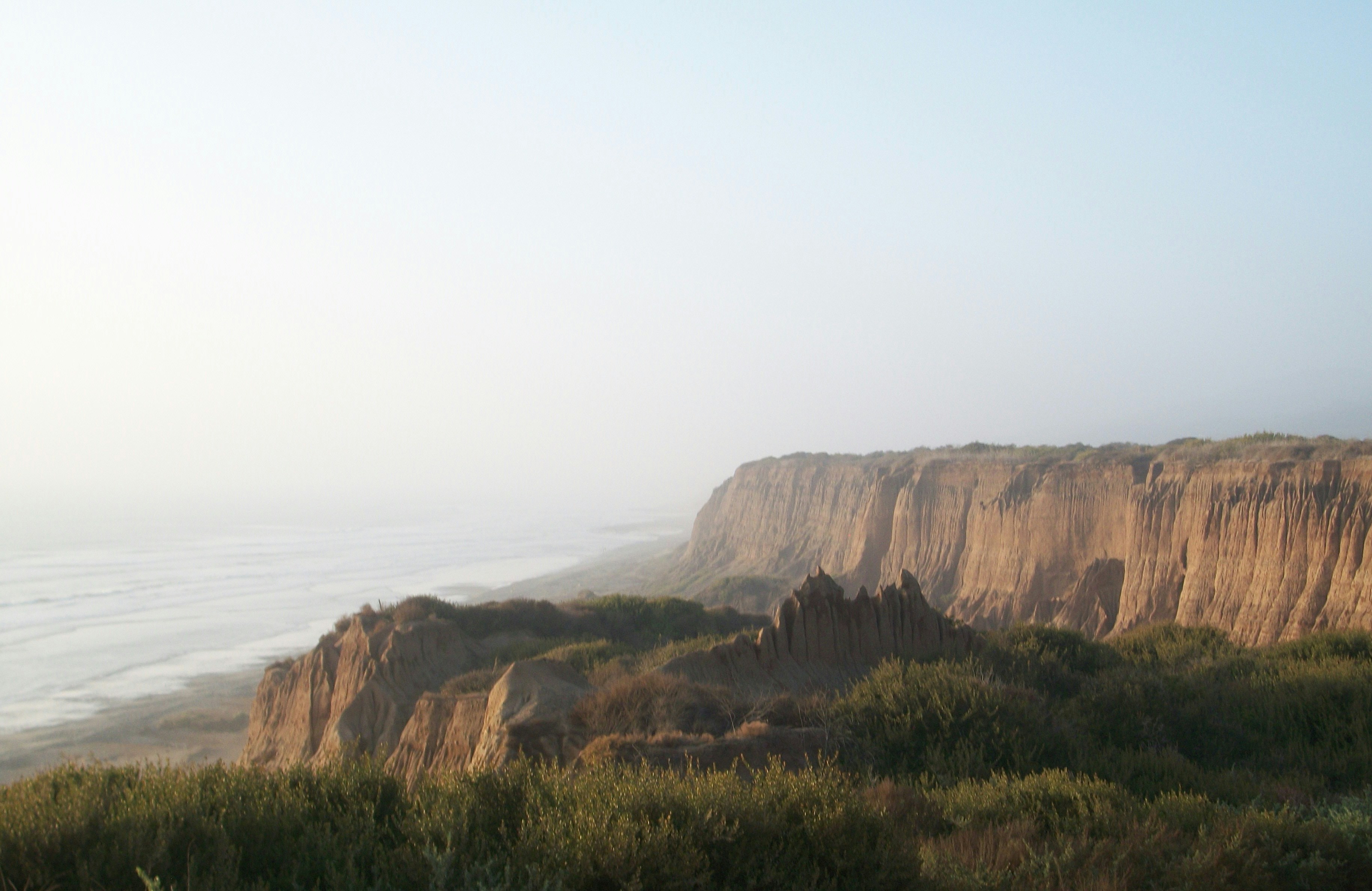 A view of a cliff overlooking a body of water