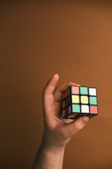 A person holding a rubik cube in their hand