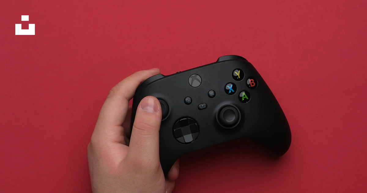 persons holding a red and black remote controllers ·... A person holding a remote control in their hand photo – Free Technology ...