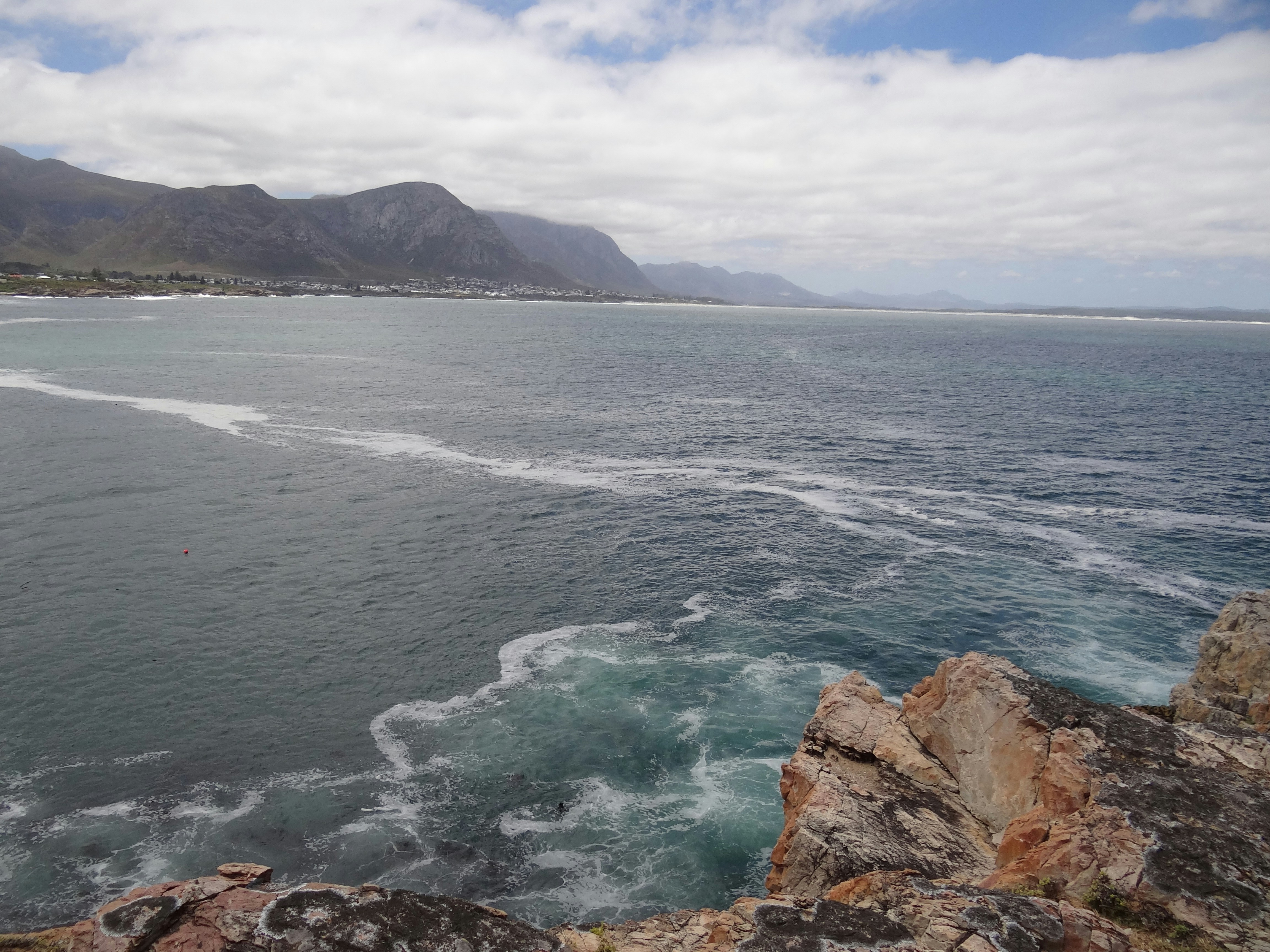 A view of a body of water with mountains in the background