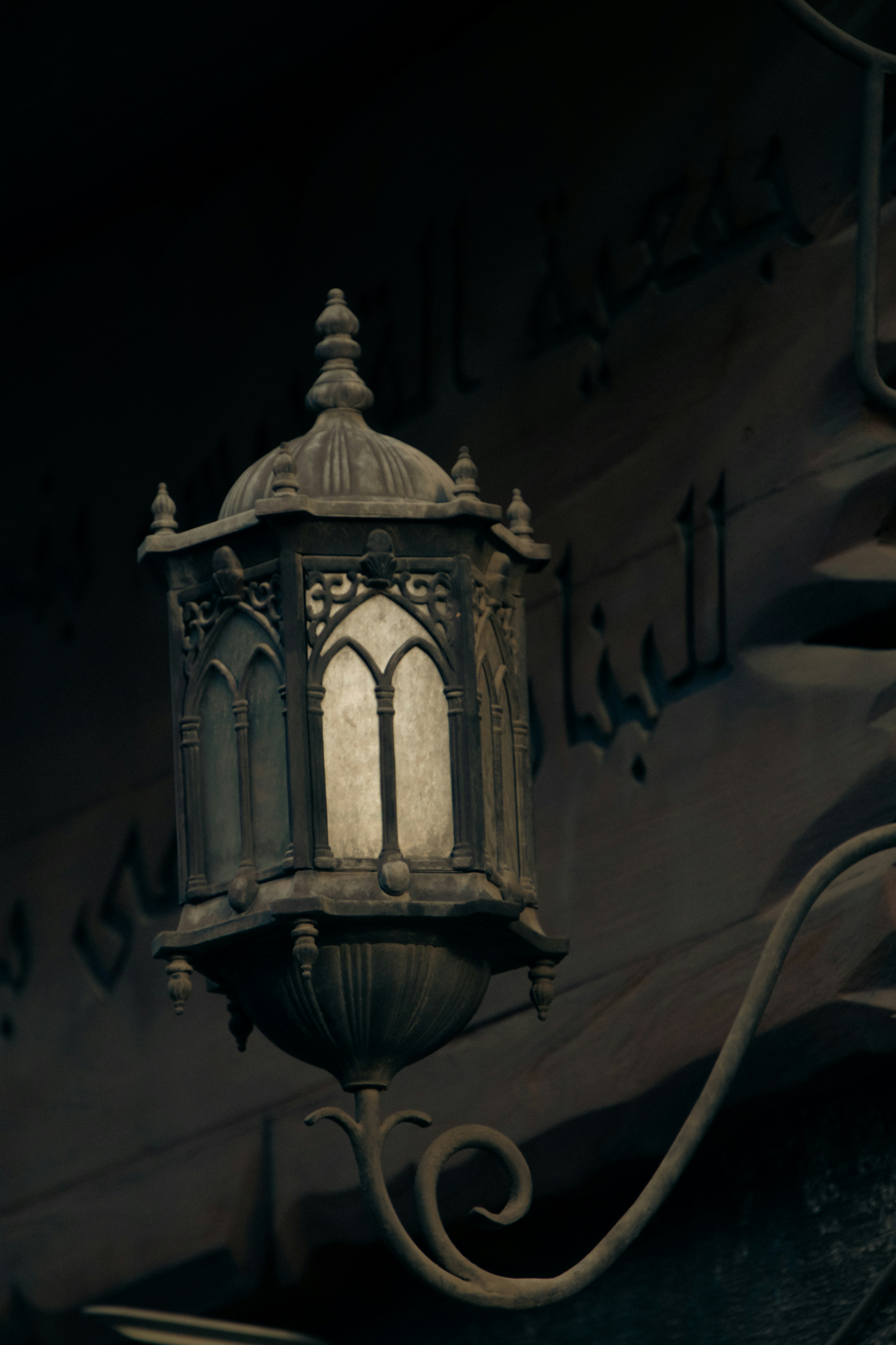 An old fashioned street light hanging from a building