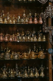 A shelf filled with lots of different types of pots and pans