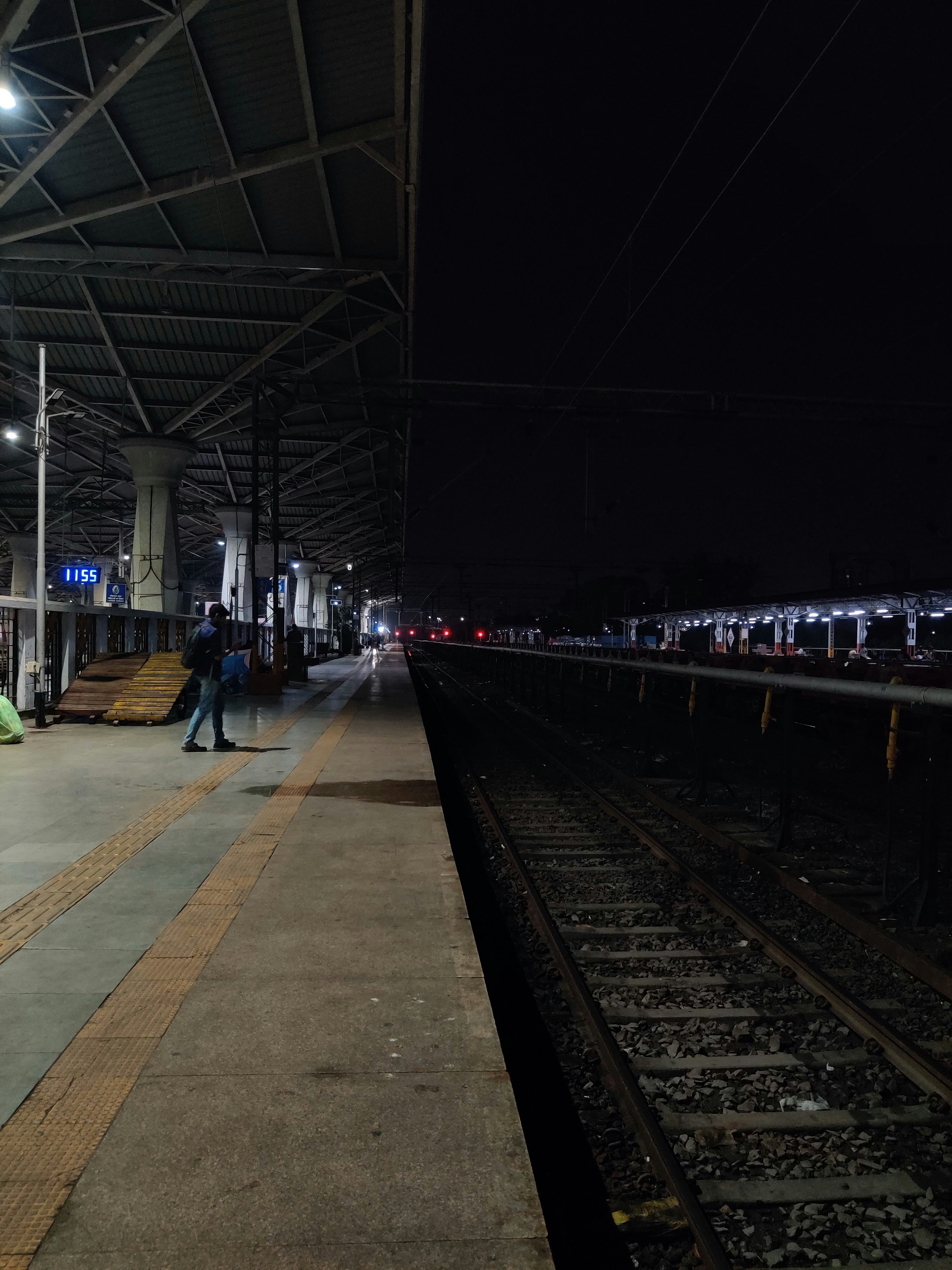 A train station with people waiting for the train