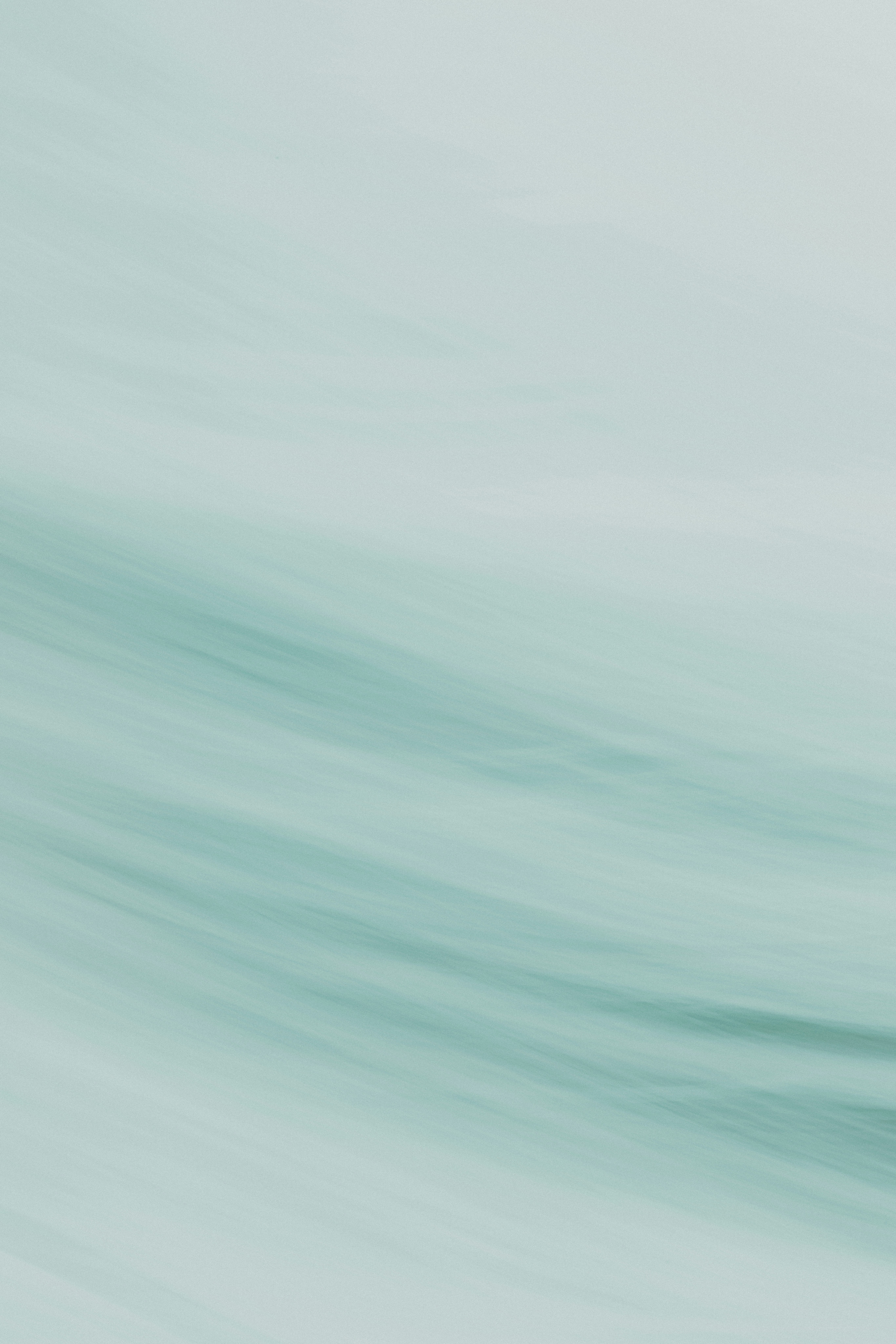 A person riding a surfboard on a wave in the ocean