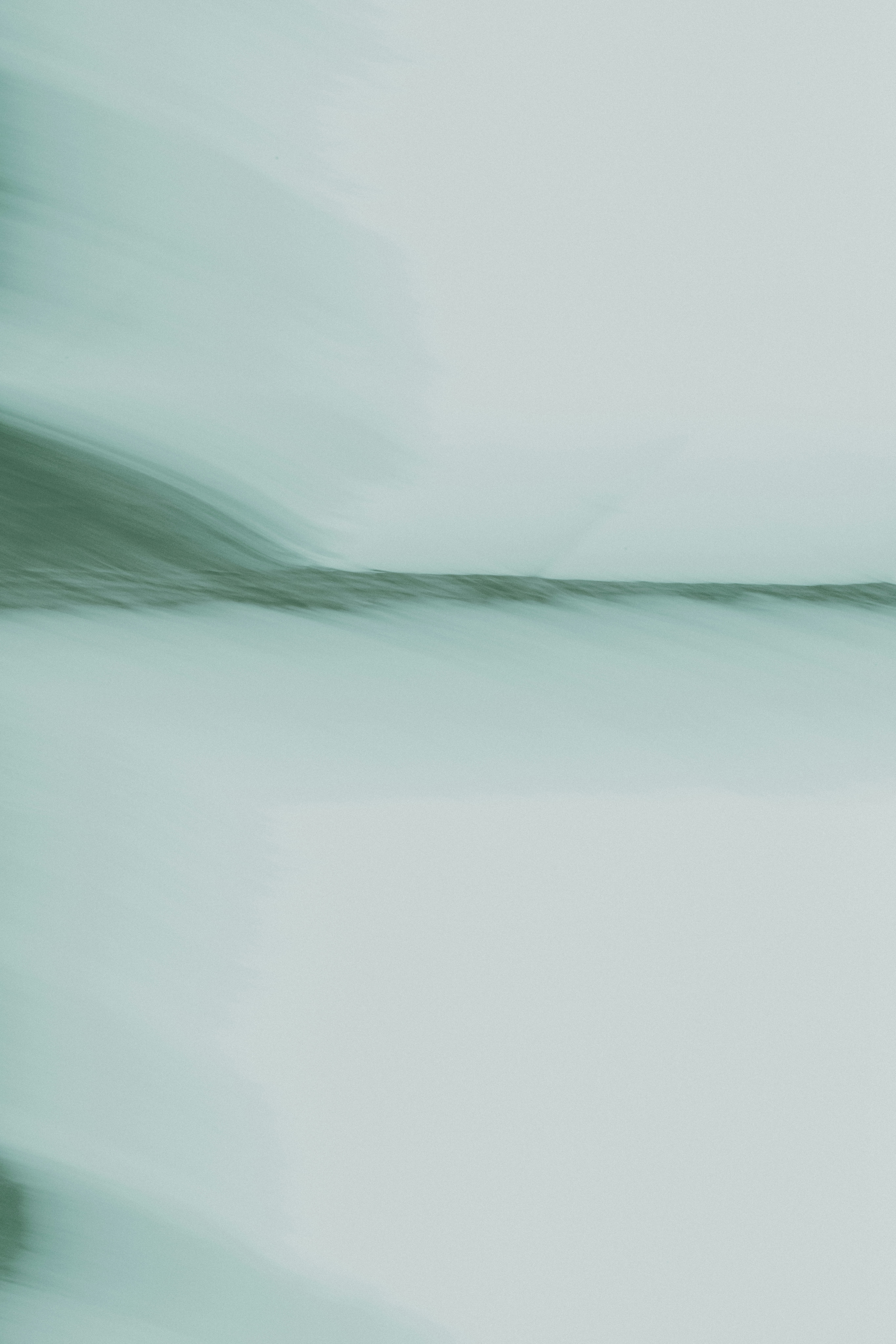 A blurry photo of a bird flying in the sky
